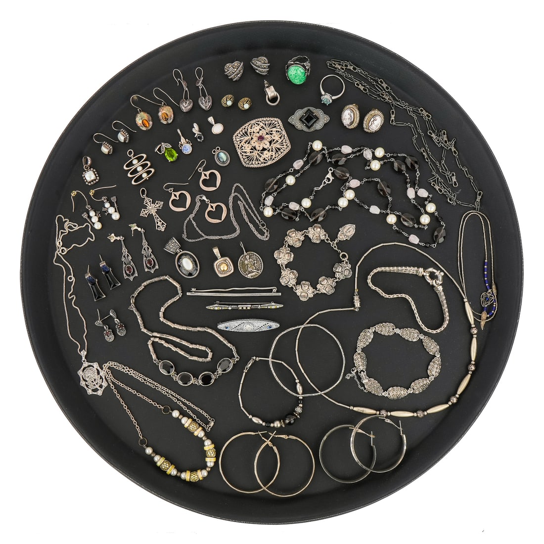 Collection of Sterling Jewelry: A fine collection of sterling jewelry including catseye earrings, garnet earrings, onyx earrings, turquoise cabochon ring, hoop earrings, flower bracelet, bracelet, bar pins, pearl earrings, and much 