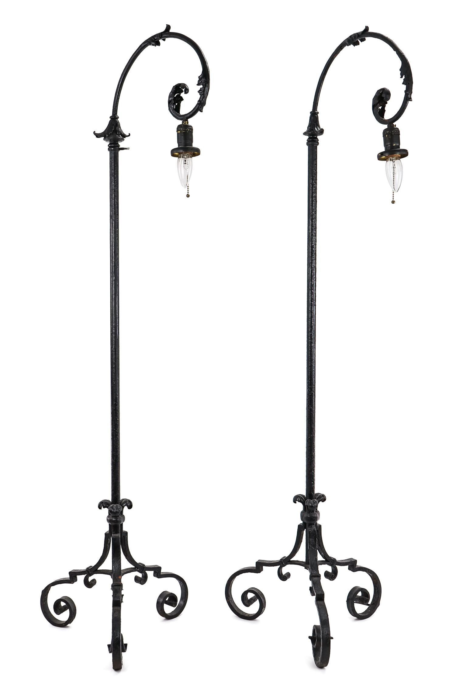 Pair of Wrought Iron Floor Lamps: A pair of vintage scrolled feet wrought iron floor lamps with acanthus accents. Adjustable height, 54" when not extended.
