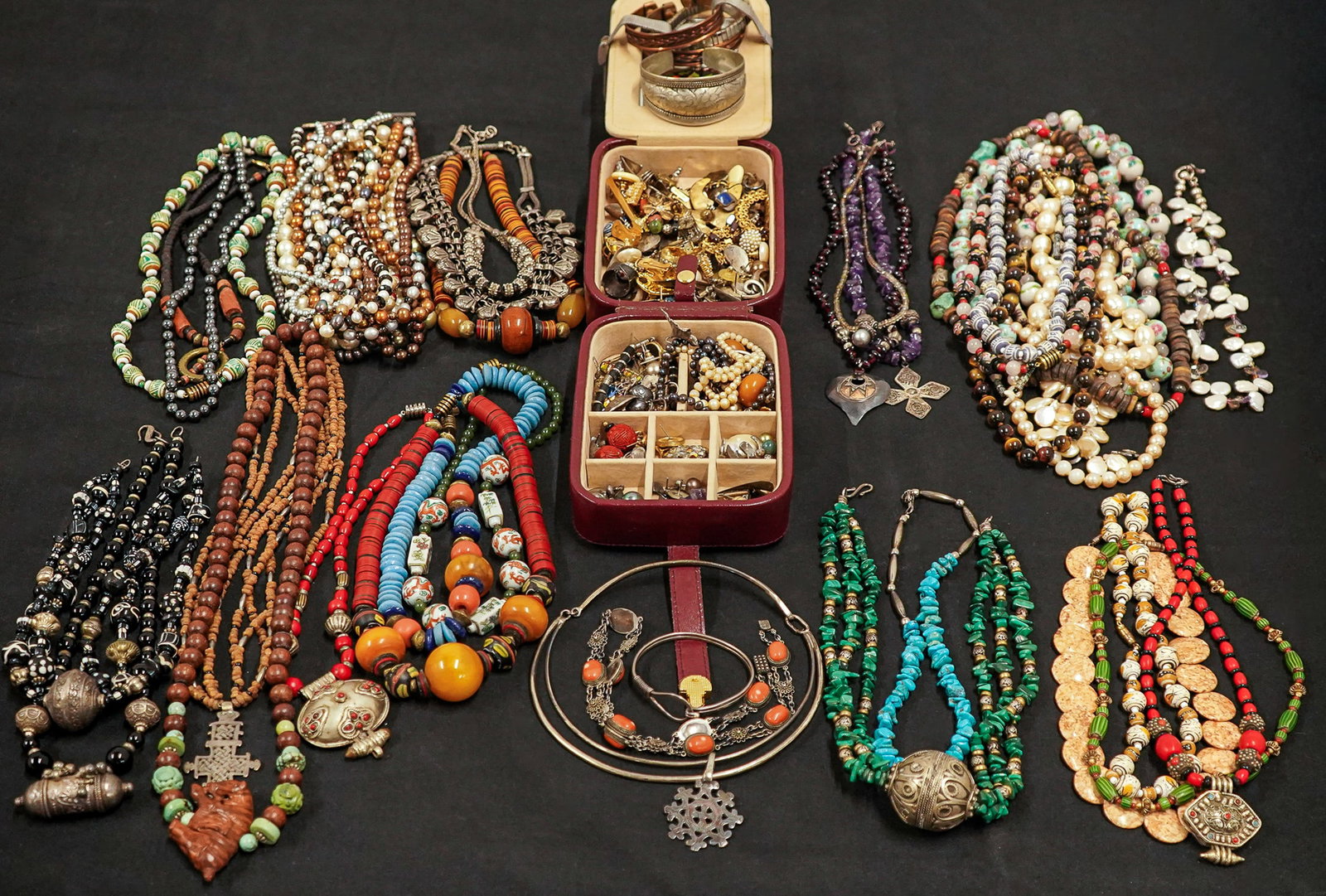 Large Lot of Costume and Silver Jewelry: Large lot of assorted costume and silver jewelry including cuff bracelets, amethyst, turquoise and malachite necklaces, tigers eye beads, silver choker, simulated pearls, world travel souvenirs, earri