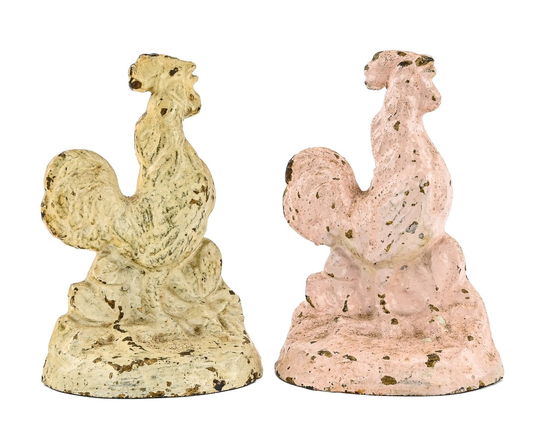 Rooster Cast Iron doorstops (Pair): Pair of cast iron painted doorstops depicting roosters in pink and white. Paint exhibits some chipping consistent with age and use. Each measures approximately 6" H x 4.5" W.