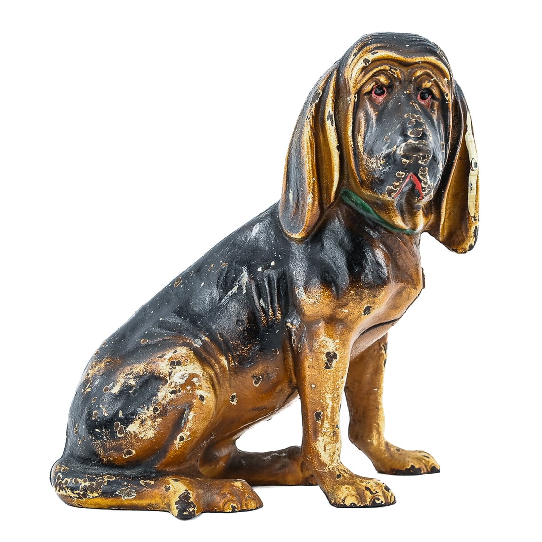 Basset Hound Cast Iron Doorstop: Cast iron doorstop in the form of a basset hound, likely Hubley manufacture. Retains traces of original paint with wear from age and use. Measures approx. 7" T x 6" L.