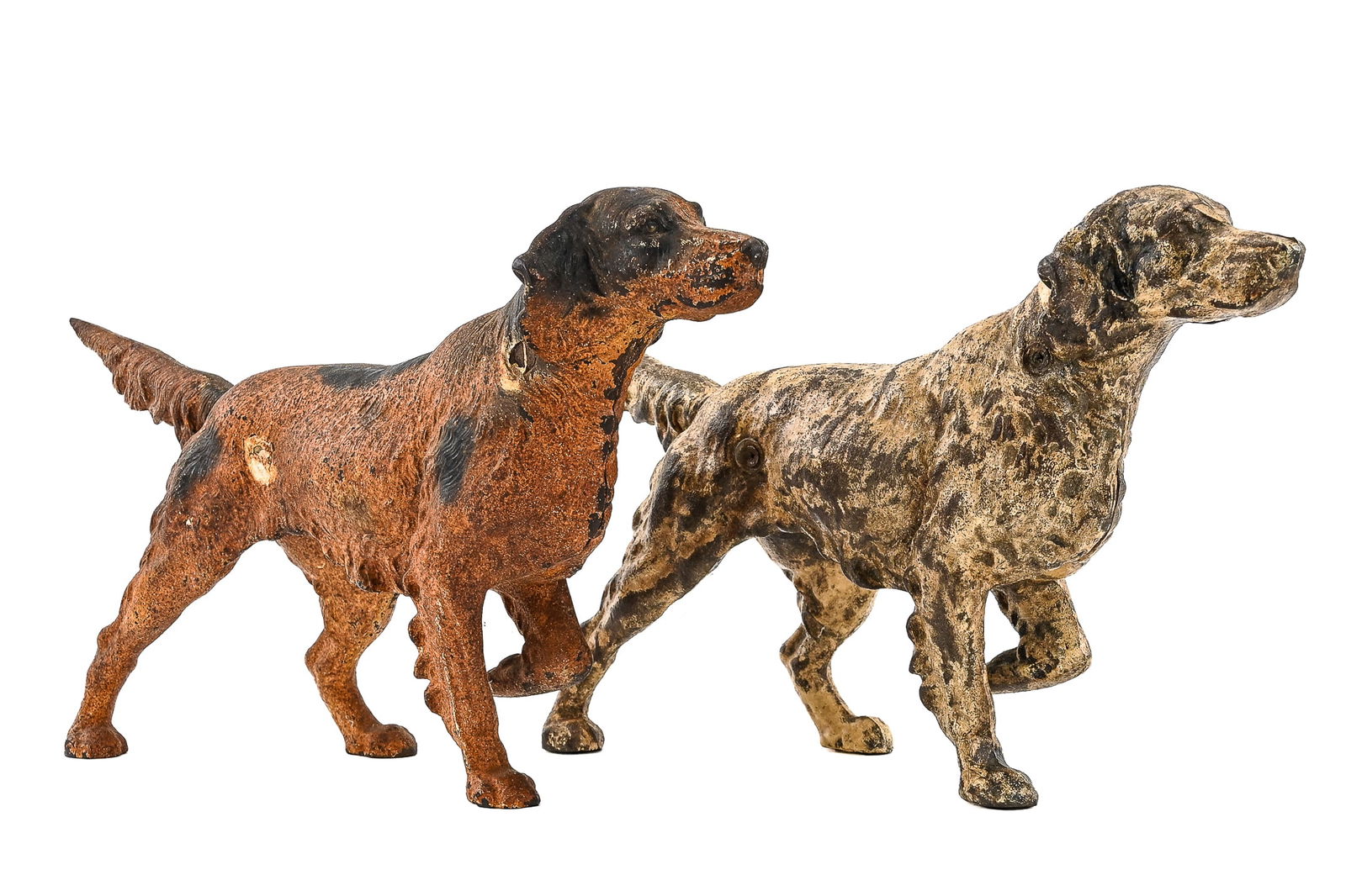 Hubley Cast Iron Setter/Pointer Dog doorstops (2 Pieces): Two Hubley cast iron doorstops depicting setters or pointers. One features a corroded orange finish, the other a worn white and black paint. Both retain character from age and use. Approx. 14" L x 9"