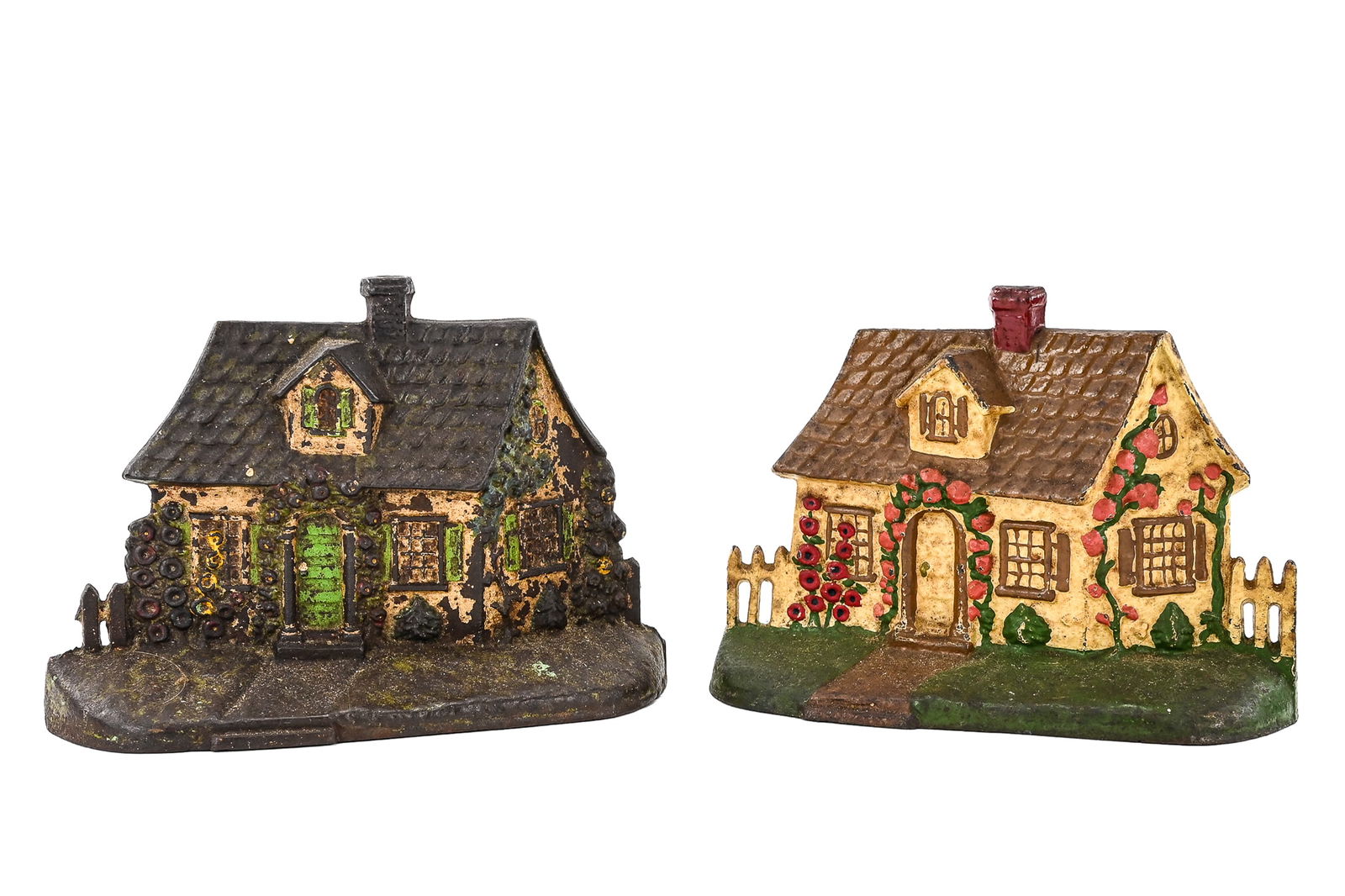Cast Iron Cottage doorstops (Pair): Pair of cast iron doorstops in the shape of cottages. Retain painted surfaces with age-appropriate wear. Each measures approx. 7" H x 6" W.