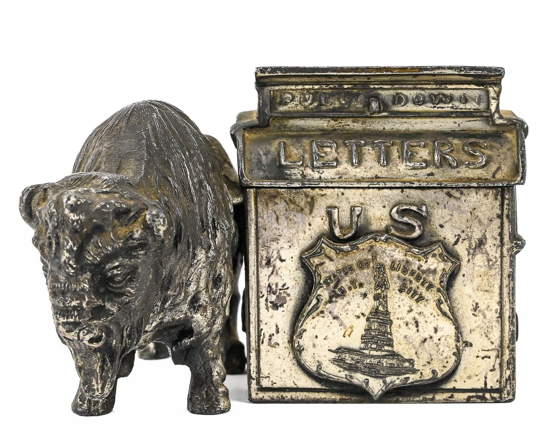 Buffalo with Mailbox Cast Iron Coin Bank: Cast iron coin bank depicting a buffalo with an attached mailbox. The mailbox features a badge inscribed with the Statue of Liberty and “NY City.” 3" x 4"