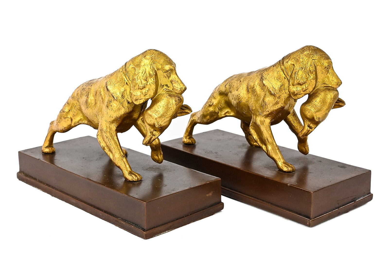Jennings Bros. Gilt Hunting Dogs with Rabbits Bookend: Jennings Bros. gilt metal bookend depicting hunting dogs with rabbits, featuring a felt bottom over a metal base. Measures approx. 6" L x 5" T.