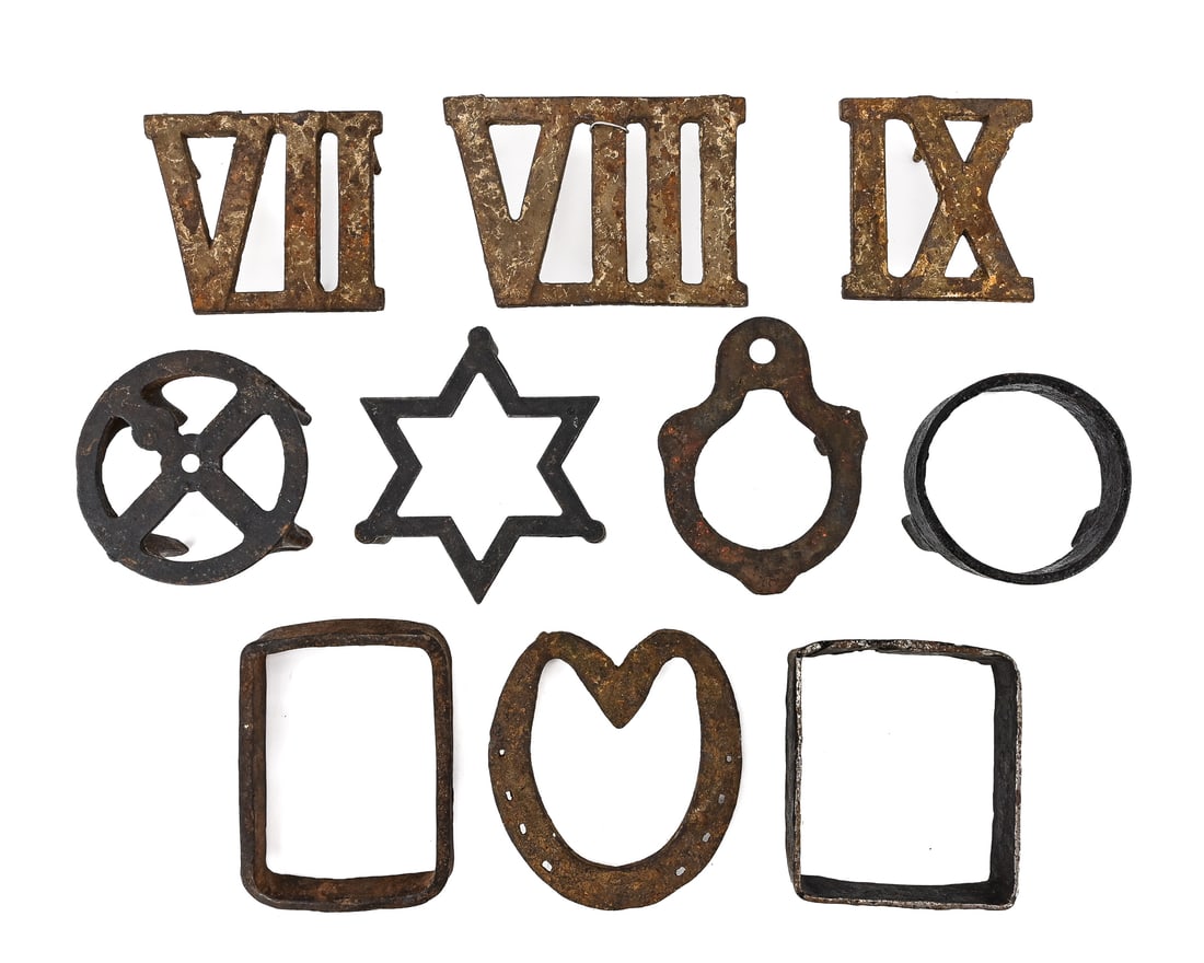 Group of 10 Early Cast and Wrought Iron Trivets: Ten early cast and wrought iron trivets in various forms including squares, rectangles, six-pointed stars, three-legged stands (approx. 3" legs), and a horseshoe with heart shape. Retain original pati