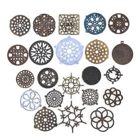 Group of 22 Cast Iron and Enamel-Painted Trivets