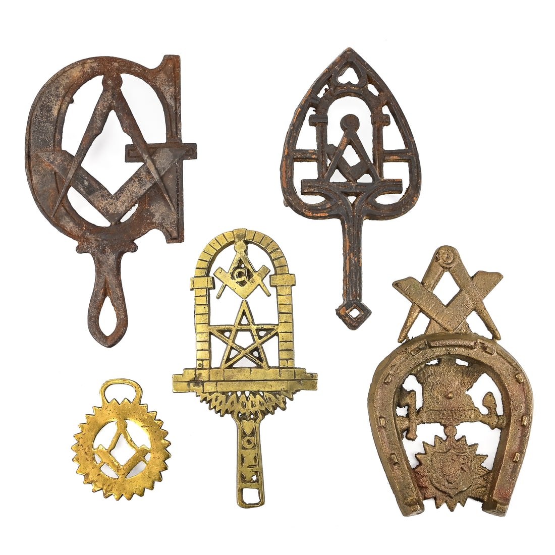 Group of 5 Masonic/Shriner Trivets: Five Masonic and Shriner-themed trivets in gilt-brass and cast iron. Largest measures approx. 9" L including the handle.