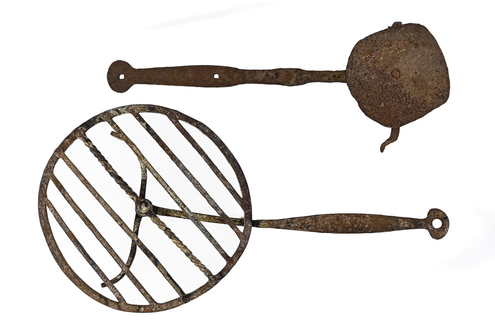 Pair of Wrought Iron Gridirons: Two wrought iron blacksmith-made gridirons/trivets, historically used in fireplaces to keep food warm. One with a rotating grated top, 24" L including the handle; the other 22" L, likely 18th century.