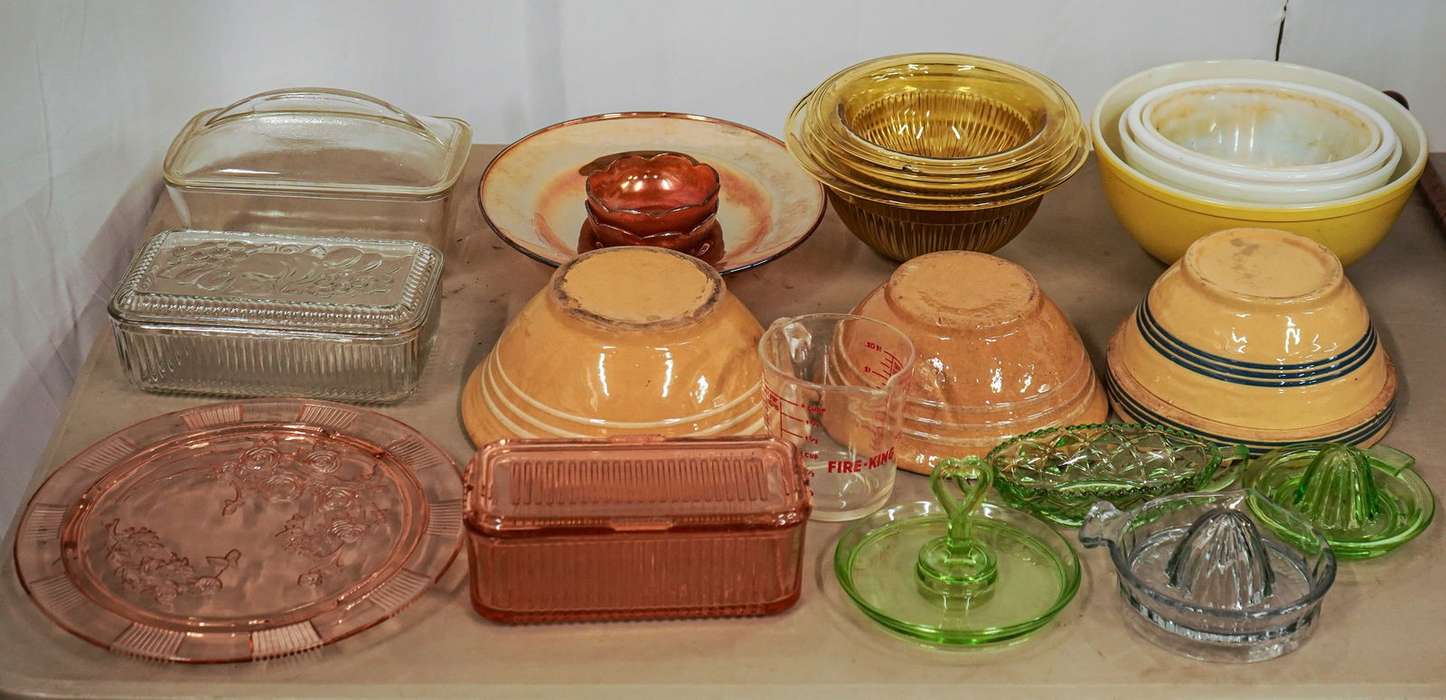 Depression Glass, Yellowware, & Pyrex: Vintage kitchen tableware including 3 banded yellow ware bowls, juicers, refrigerator jars, set of 4 nesting amber depression glass bowls, and Pyrex bowls.