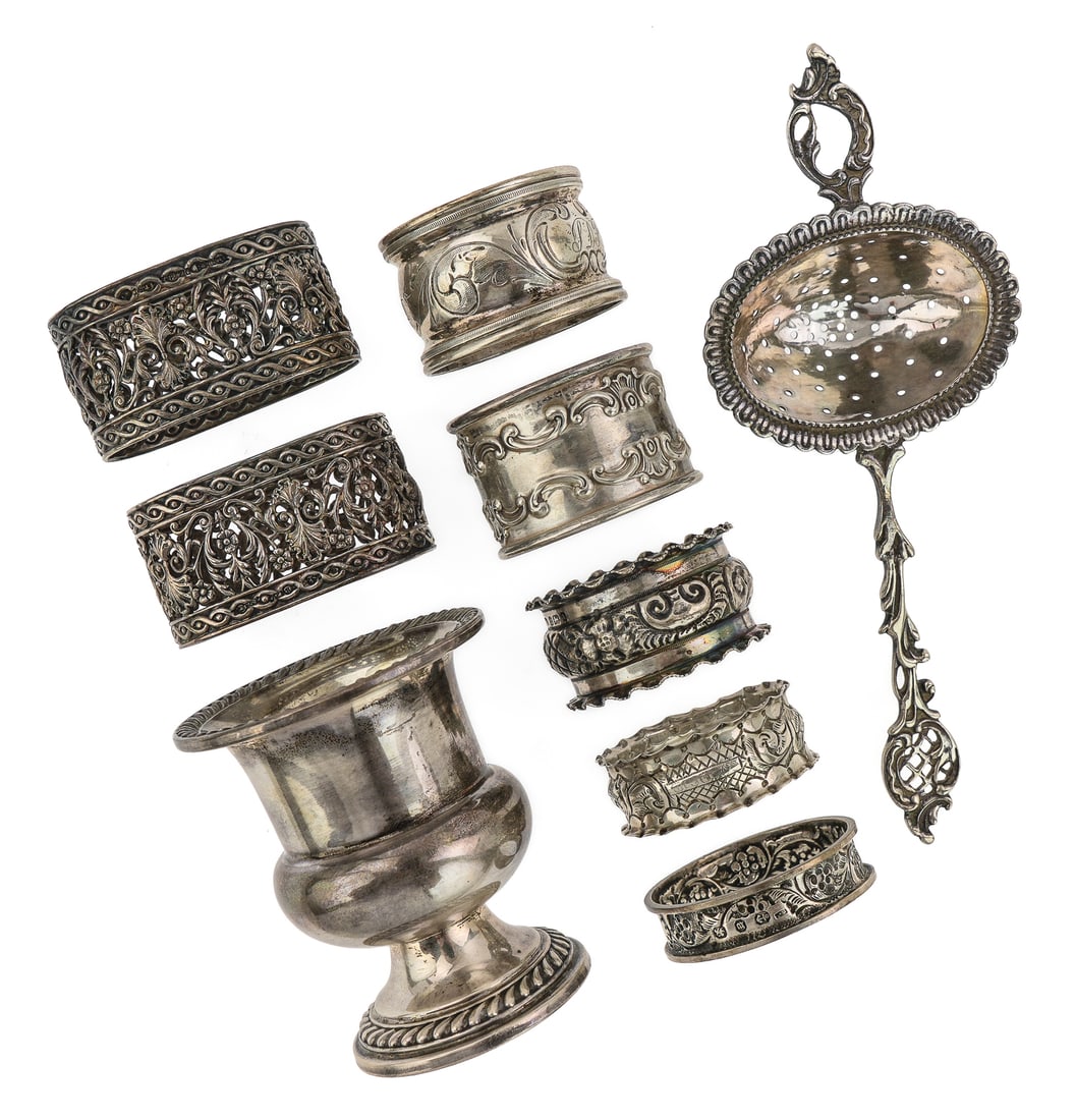 Sterling Tea Strainer, Urn and Napkin Rings: Group of sterling silver tableware including small gadrooned urn toothpick holder, tea strainer, pair of fine classical reticulated napkin rings, 5 assorted repousse napkin rings 2"-6.5" 7.9 ozt.