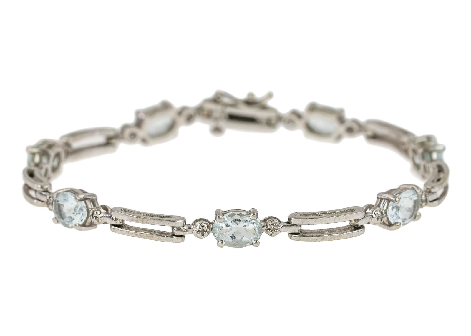 10k White Gold Aquamarine & Diamond Tennis Bracelet: 10k white gold tennis bracelet with 7 oval cut aquamarines approx 1 CT each with two .01 ct diamonds. 7 1/8" long. 8.8 grams t.w.