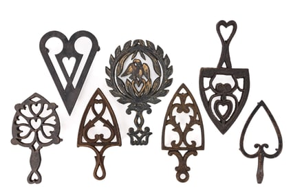 Group of 7 Cast Iron Decorative Trivets