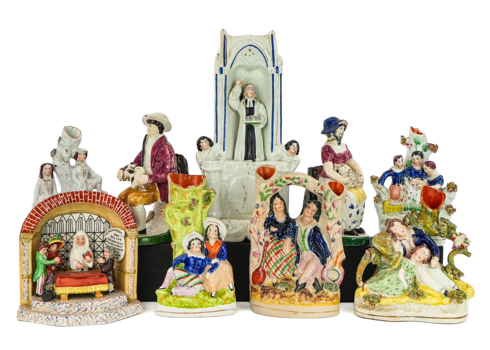 19th c. Staffordshire Pottery Mantel Figures: Group of nine mid 19th c. Staffordshire pottery mantel figures including John Wesley in pulpit, romantic couples, huntsman with dog, children, etc. 6"-11" some losses, imperfections