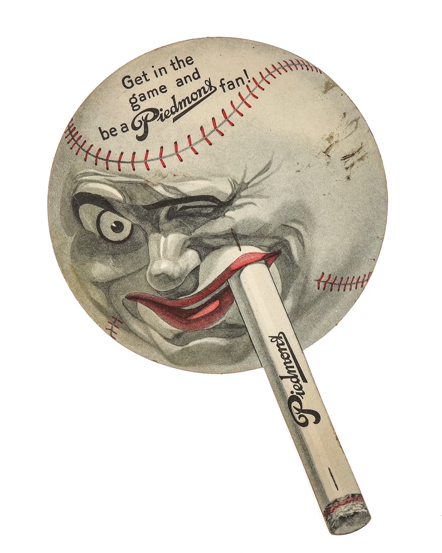 Piedmont Smiling Baseball Advertising Fan: Ca. 1910 Piedmont Cigarette Advertisement on a fan in the form of a baseball with a face. "Get in the Game and be a Piedmont Fan!". 11" long. Overall very good condition for age.
