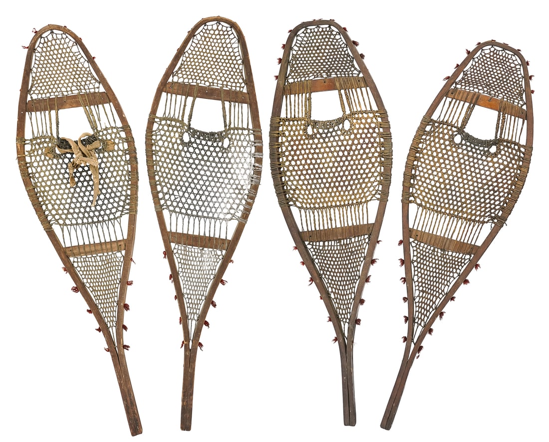 Two Pairs of Late 19th c Snowshoes: Late 19th- early 20th c Canadian Indian made snowshoes (2 pr), with tufts of red wool, one pair in excellent condition, the other with slight damage, old repair, lengths 37"