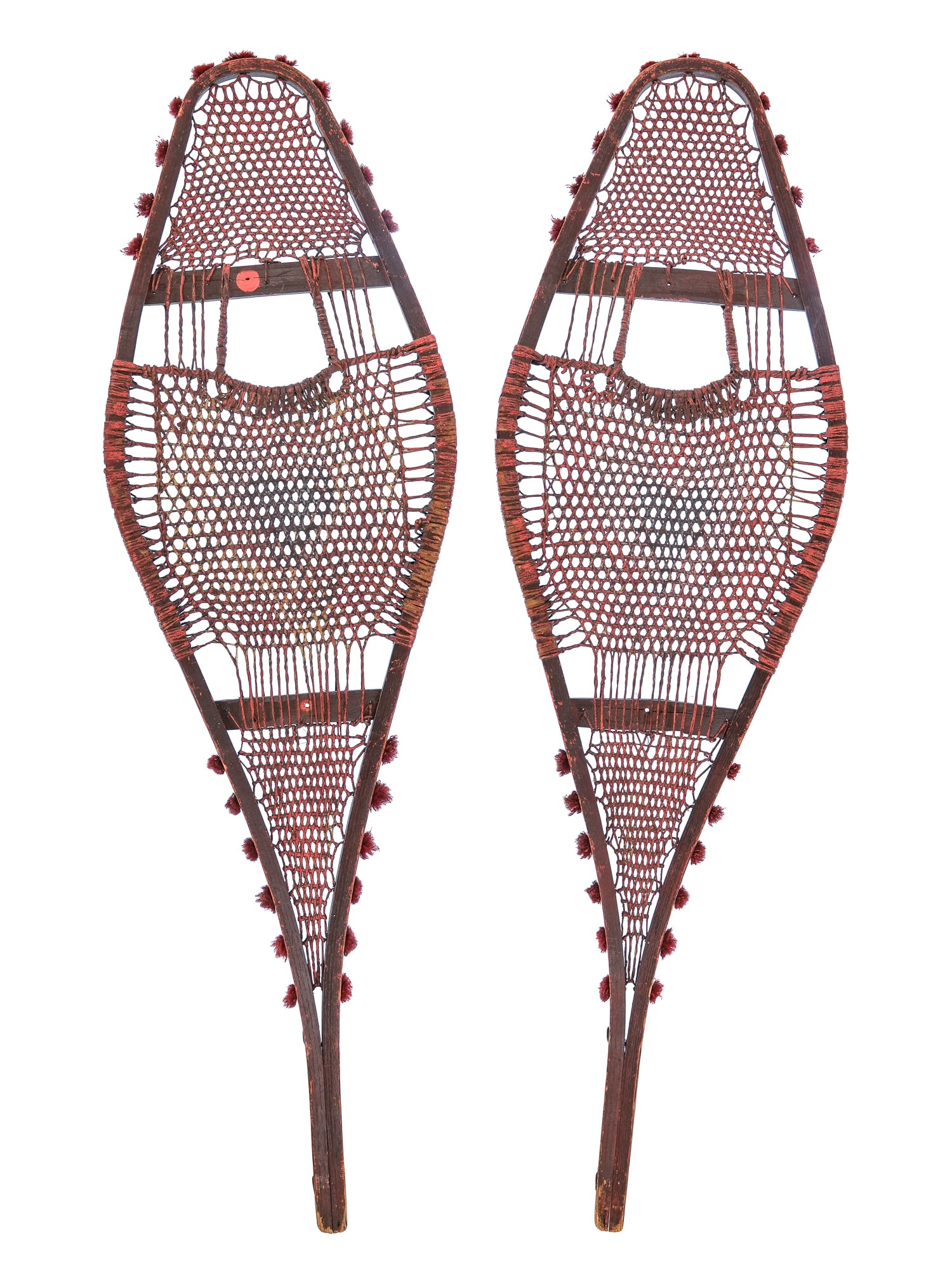 Early Native American Indian Snowshoes: Early 20th c Native American Indian snowshoes in a red wash, red wool tufting, 36 1/2" length