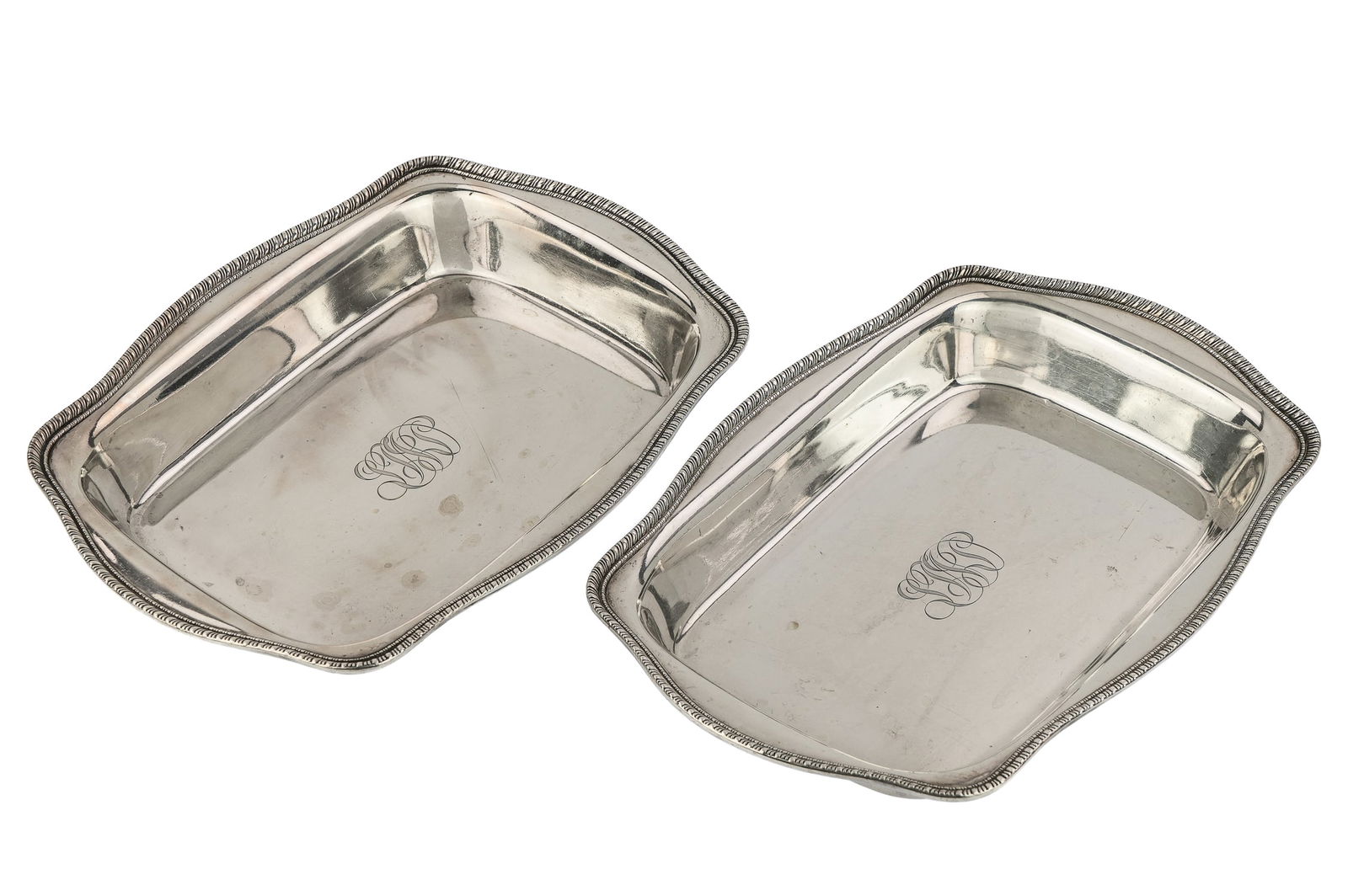 Pair of Whiting Sterling Silver Serving Dishes: Pair of early 20th c. Frank M. Whiting sterling silver rectangular serving dishes having scalloped gadrooned rims, cursive script monogram in center 7.5" x 10.75" -30.4 ozt. some slight abrasion, over