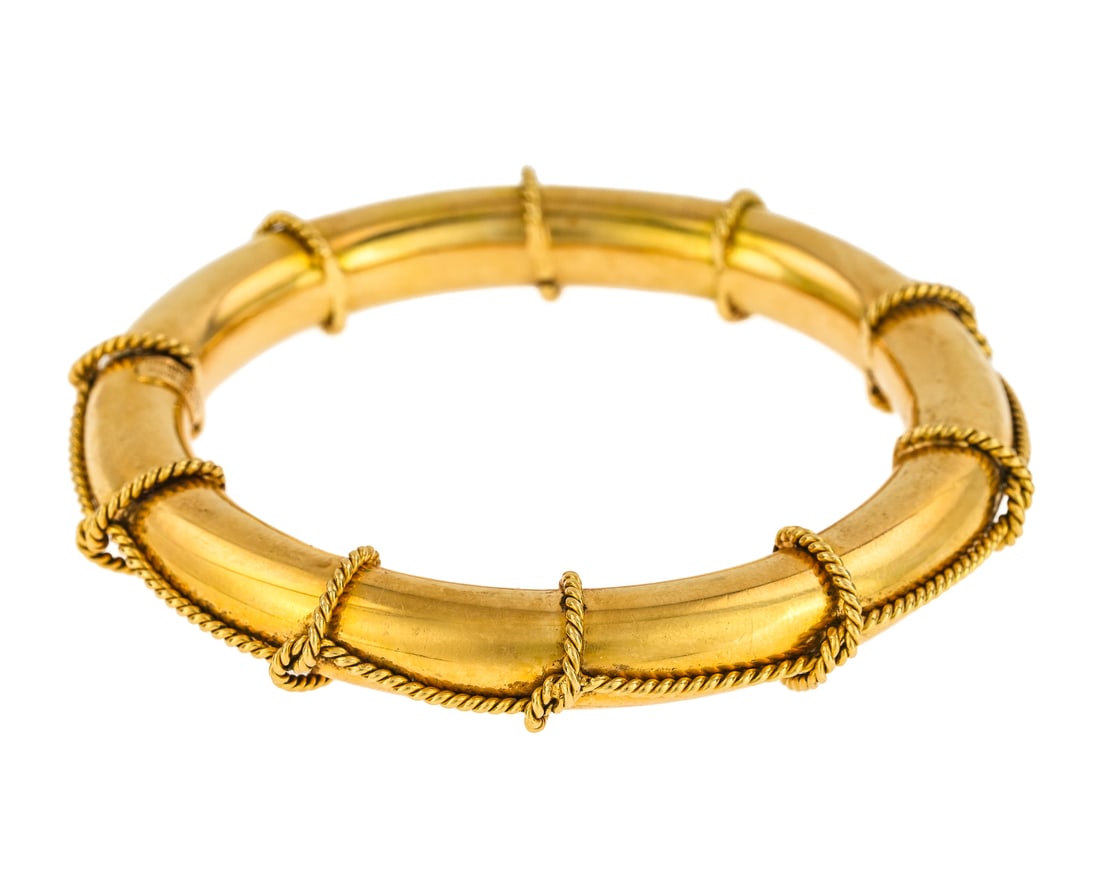 Tiffany 18k Yellow Gold Bangle: Tiffany & Co. 18k yellow gold Italian bangle. 11 mm wide tube with rope twist accent. 2 1/2" opening, 3 1/2" exterior. 51.5 grams t.w. With Tiffany & Co. Deep blue leather box.