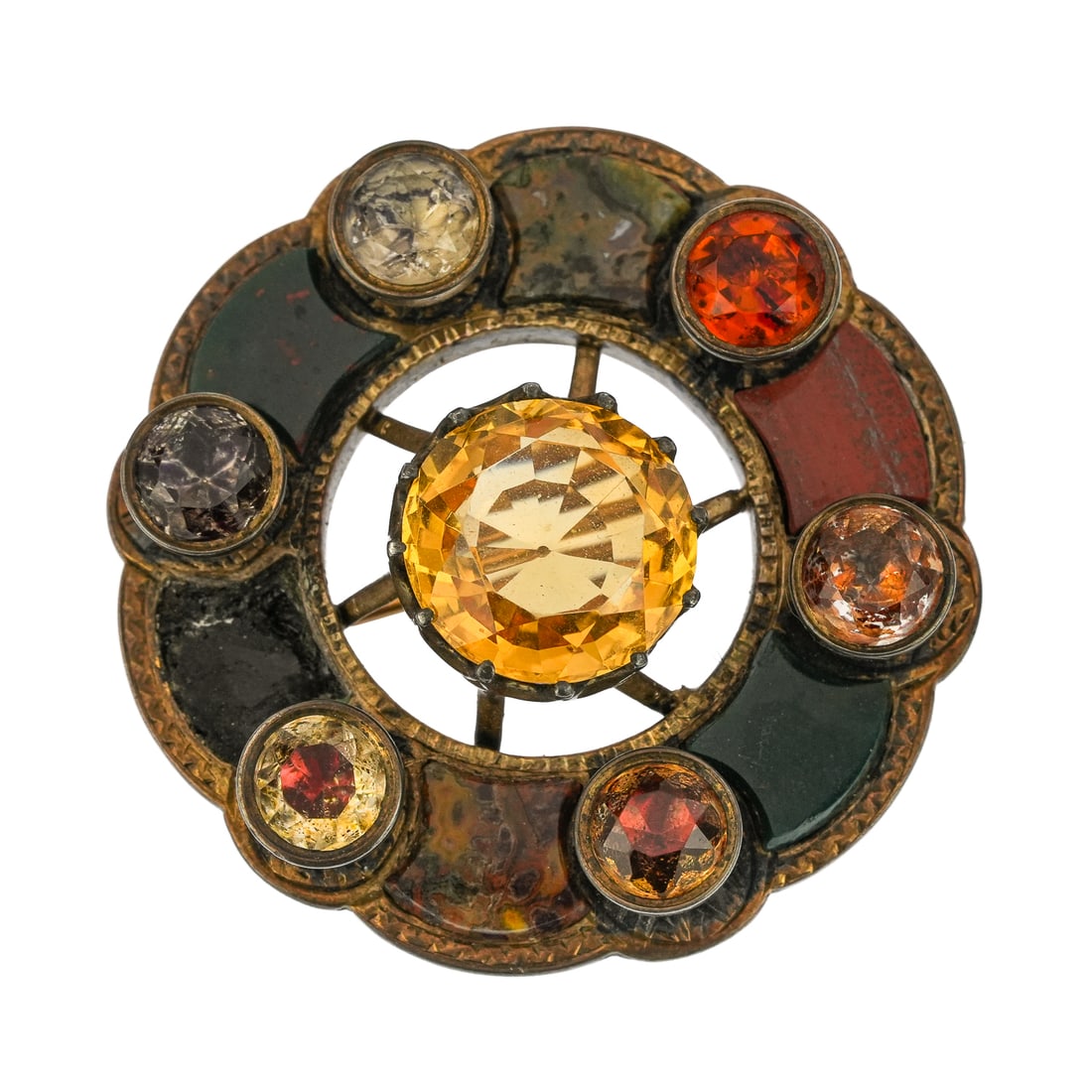 Scottish 19th c Silver & Gemstone Brooch: 19th c Scotland silver brooch pin set with 6 round cut gemstones 8 mm diameter of amethyst & garnets, with center round cut 17 mm citrine, and various hardstone polished panels. 2" diameter.