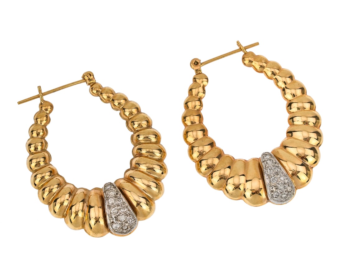 Diamond & Yellow Gold Hoop Earrings: A pair of 14k yellow gold Huggies hoop earrings. Each set with 10 round cut .015 ct diamonds in white gold, approx. .30 cts.t.w. 1 1/2" long. 5.5 grams t.w.
