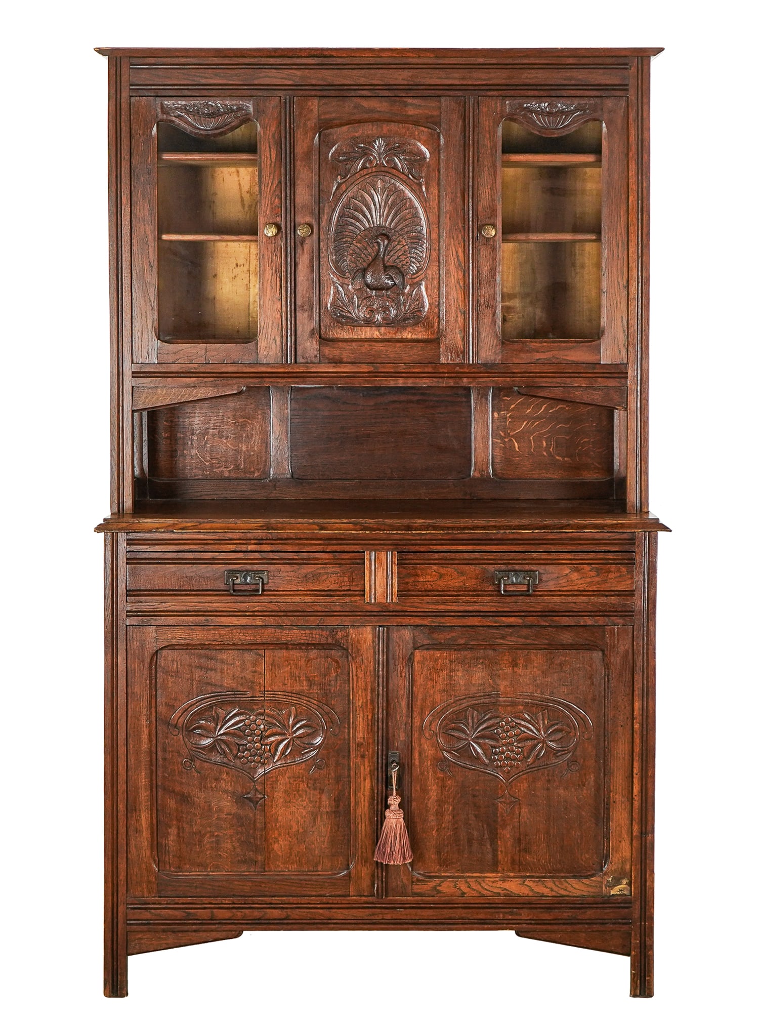 Circa 1930 Oak Server: Circa 1930 Oak server two pieces with stepback top with central panel carved with Peacock decoration and brides baskets above glazed doors. 81 x 49 x 18"