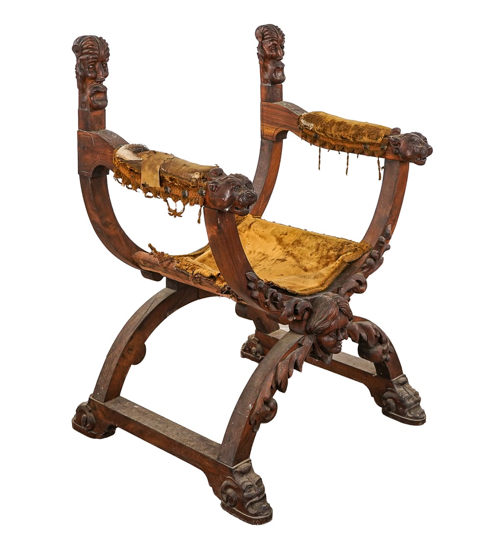 19th c Savonarola chair: 19th c Continental walnut Savonarola Chair with finely carved lion armrests, acanthus foliate decorations, and grotesques at the seat stays and feet missing back with remnants of velvet seat. 41 x 24