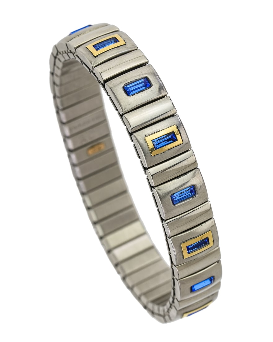 18k, Stainless, & Tanzanite Bracelet: RCI elastic stainless steel bracelet set with 16 panels with a center baguette cut blue tanzanite, alternating each with a 18k yellow gold surround. 10 mm wide bracelet.