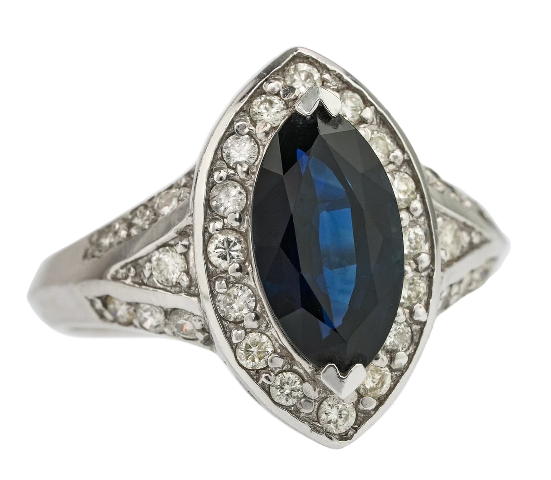 Marquise 3 CT Sapphire & Diamond Ring: 14k white gold ring set with a 3 CT marquise cut sapphire and 30 small round cut diamonds in surround, approx. 1 CT.T.W diamonds. Ring size 6.5.