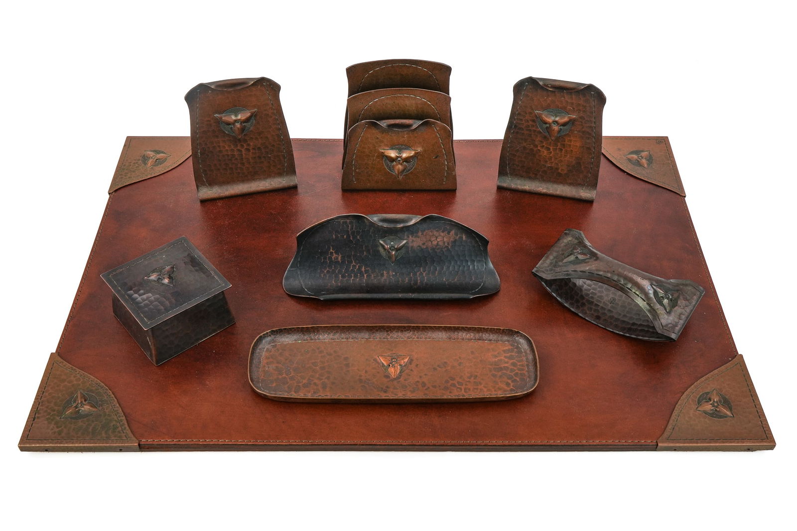 Roycroft Trefoil Desk Set Pieces: Roycroft "Trefoil" desk set pcs (11 pcs total), including 4 blotter corners, inkwell, letter holder, rocker blotter, pen tray, pen stand, bookends, all with Aurora or copper finishes