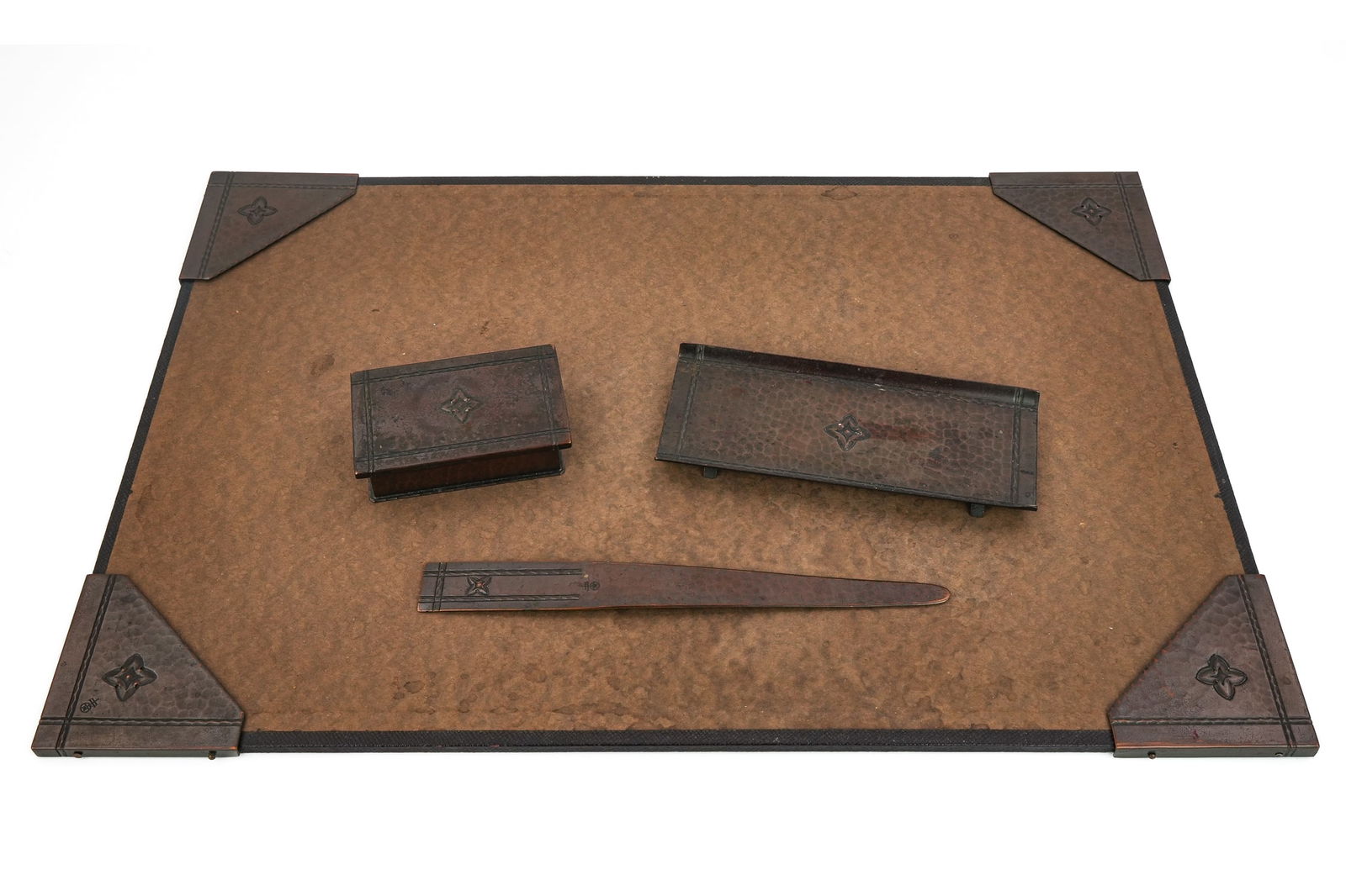 Roycroft Quatrefoil Desk Set Pieces: Roycroft "Quatrefoil" desk set pcs (7 pcs total), including 4 blotter corners, pen tray. Letter opener, stamp box, all in Aurora finish
