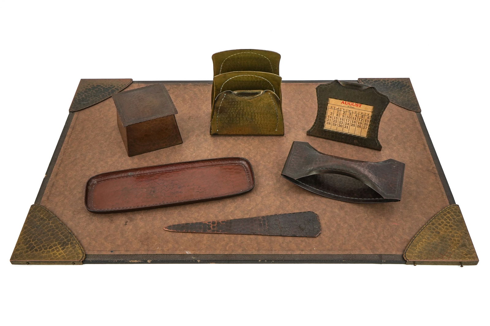 Roycroft Stitched Desk Set Pieces: Roycroft "Stitched" desk set pcs (10 pcs total), including 4 blotter corners, inkwell, pen tray, letter opener, rocker blotter, calendar, letter holder,in Auroram copper and brass finishes