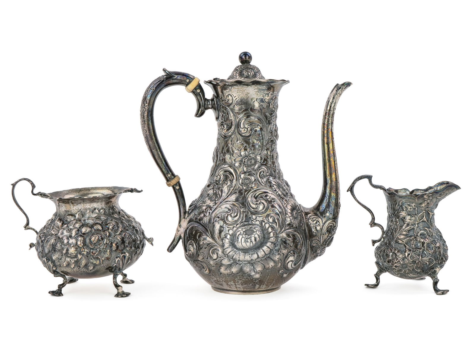 Bailey Banks and Biddle Sterling Demitasse Set: ca. 1900 Bailey Banks and Biddle Philadelphia sterling silver floral all-over repousse demitasse set including chocolate pot, open sugar bowl and footed creamer inscribed "Lucia K. Weimer" 3.5"-8"