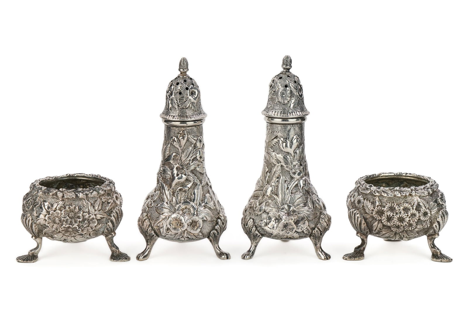 Floral Repousse Sterling Salts and Pepper Pots: ca. 1900 hand-chased all-over floral repousse sterling silver footed master salts and pair of footed pepper pots. Possibly by Bailey, Banks and Biddle, Kirk or Stieff. ht. 1.5"-4.25" 8.3 ozt.