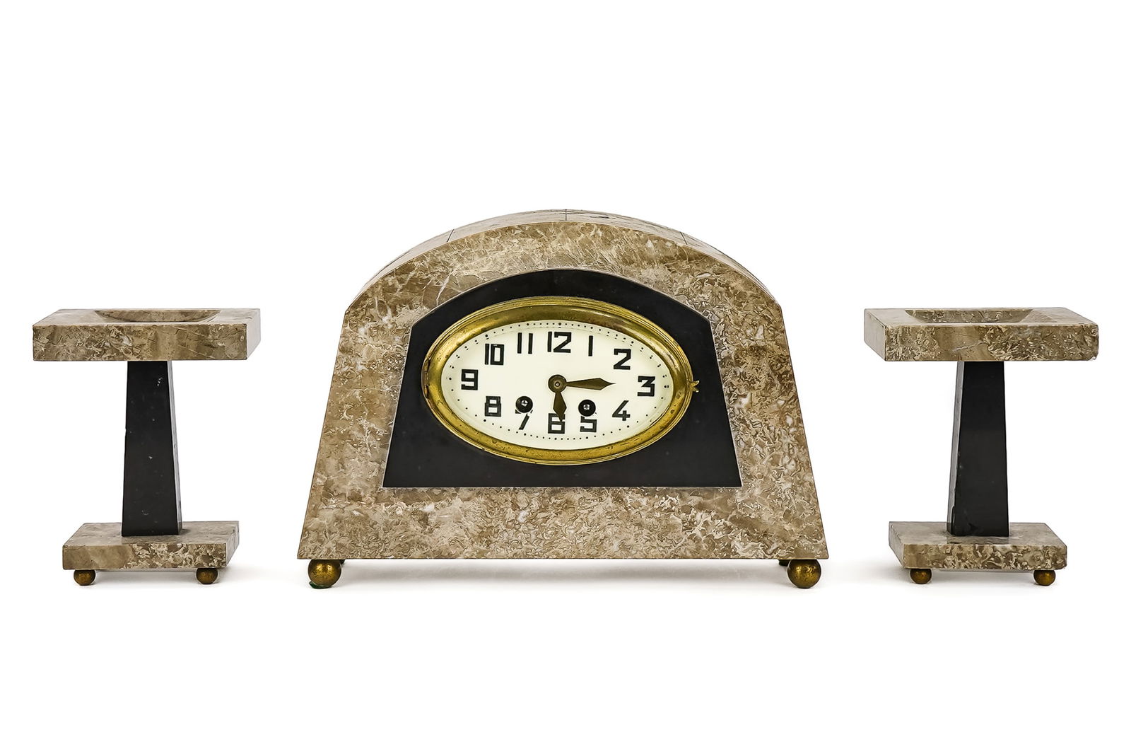 3 Piece Art Deco Clock Garniture Set: Fine 1930's 3 piece clock garniture set with travertine marble & onyx side stands on brass ball feet, 6" h. With a center clock veneered with travertine marble & onyx, oval center clock face with