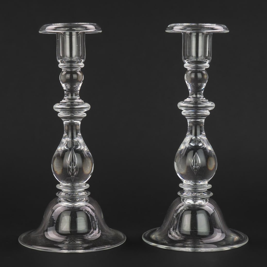 Pair of Steuben Teardrop Baluster Candlesticks: Pair of mid 20th c. Steuben blown crystal teardrop baluster form candlesticks. Signed under base, overall excellent condition. 4.25" x 9"