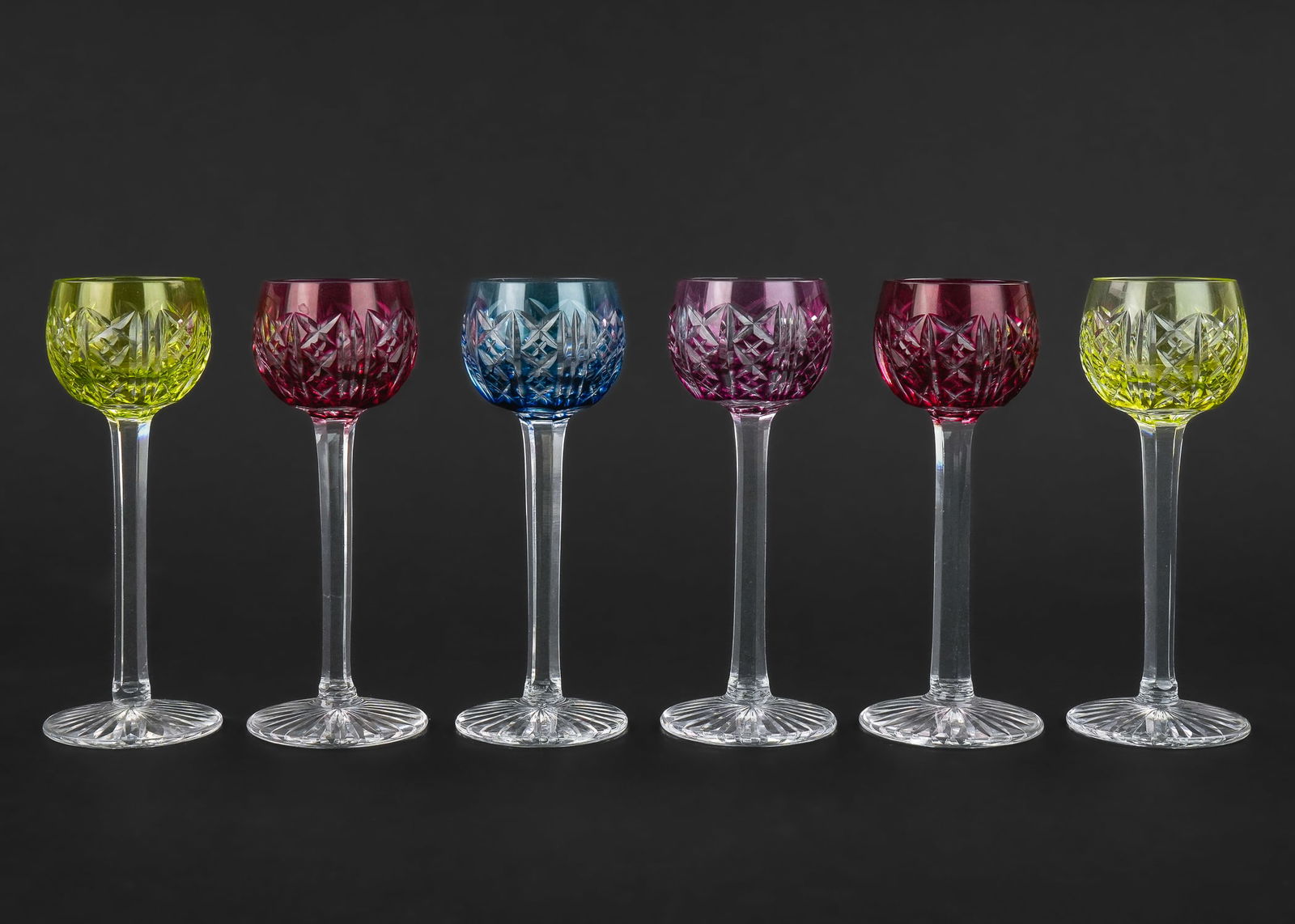 6 St. Louis Colored Flashed Cut Glass Cordials: Set of 6 St. Louis French brilliant cut glass stemmed aperitif cordials having flashed cut to clear bowls in chartreuse, canary, cranberry, violet, and cobalt blue. Acid etched mark on base. 1.5" x 5"