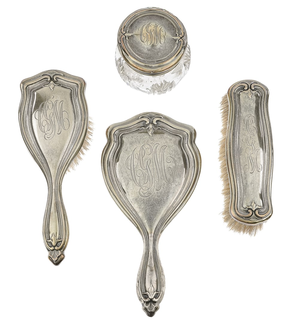4 pc. Art Nouveau Sterling Silver Dresser Set: 4 pc. ca. 1910 Art Nouveau inspired repousse sterling silver dresser set including hand mirror, hair brush, clothes brush, covered cut glass dresser jar 3.5"- 10.5"