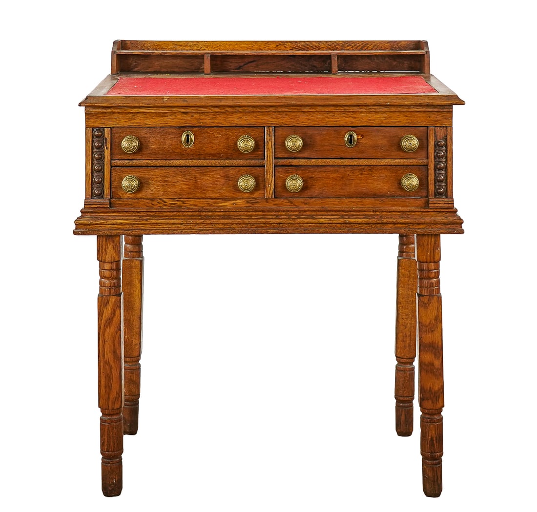 Victorian Spool Desk: 19th c Victorian oak slant top spool desk with 4 drawers on block & turned legs. Red felt writing surface. 30"w, 21"d, 36"h.