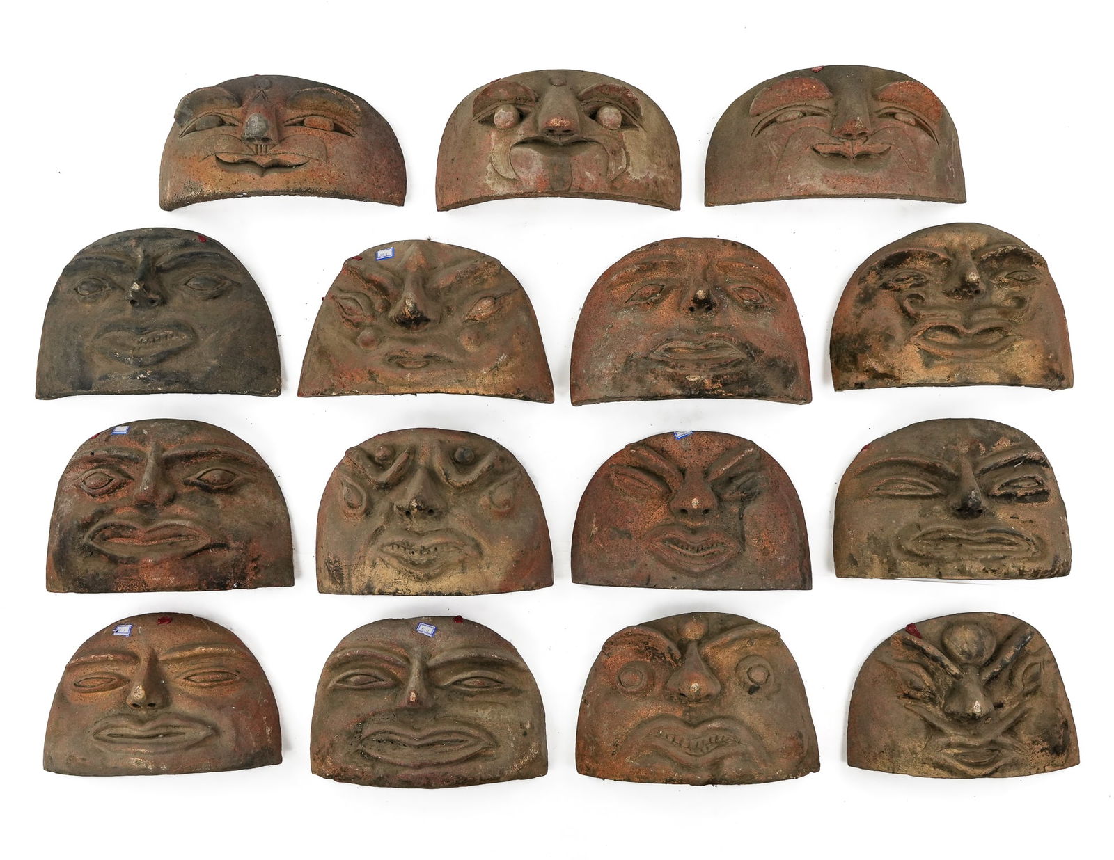 15 Chinese Terracotta Kang Stove Door Covers: 15 rare and fun 18th/ 19th c Chinese terracotta Kang (platform stove) ash door covers, folky heavy terra cotta faces with amusing expressions, each different, stand on their own without support,