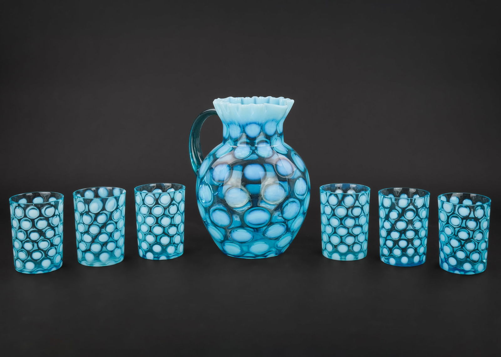 Northwood Blue Coinspot Pitcher and Tumblers: Northwood blue opalescent coinspot ruffled Victorian art glass pitcher with 6 tumblers ht. 3.5"-8.5"