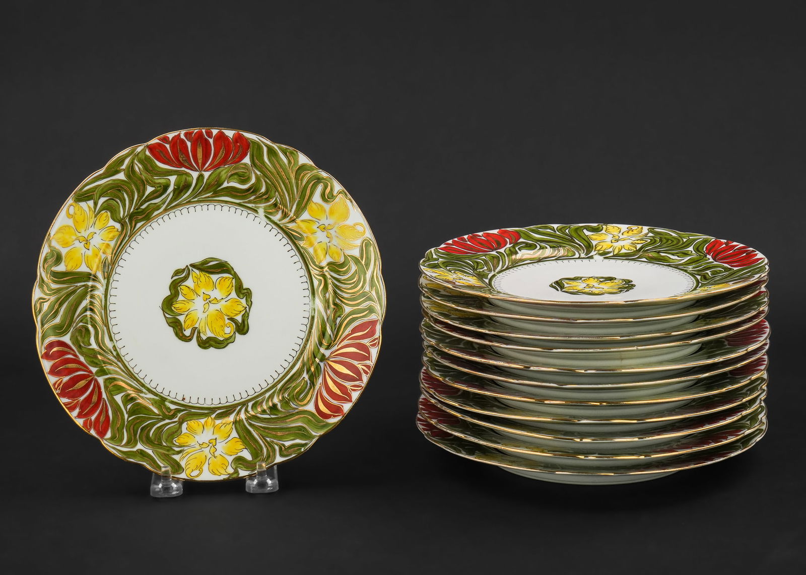 Pirkenhammer Austrian Porcelain Luncheon Plates: Set of 12 Pirkenhammer Austrian porcelain luncheon plates with green and red hand painted Art Nouveau floral motif borders and gilt accents 8.5" dia.