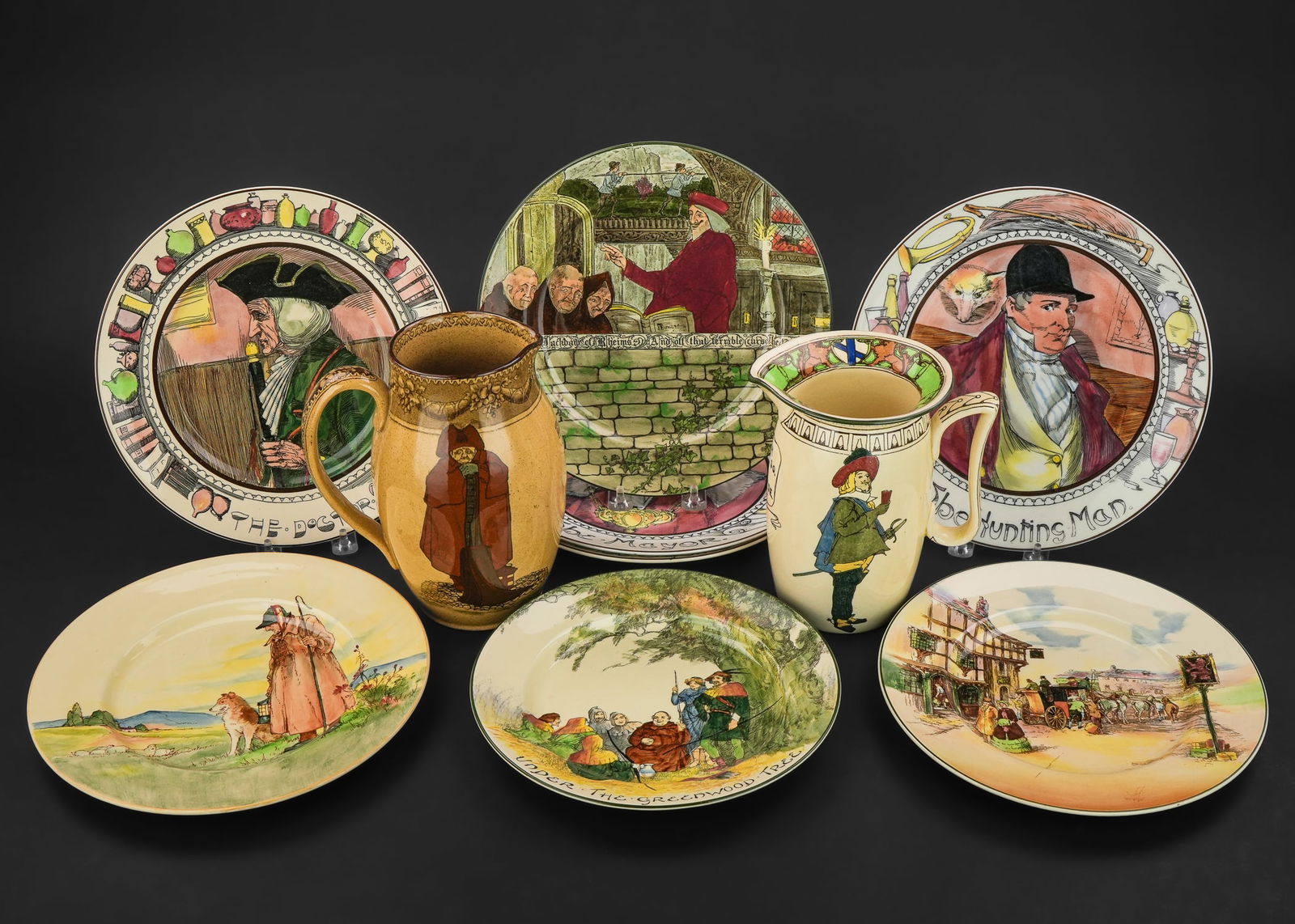 10 pcs. Royal Doulton Scenic Art Pottery: Collection of 10 pcs. of Royal Doulton Arts and Crafts era pottery including two pitchers, 8 plates with English coaching scenes, shepherd and dog, "Under the Greenwood Tree," "The Doctor," "The
