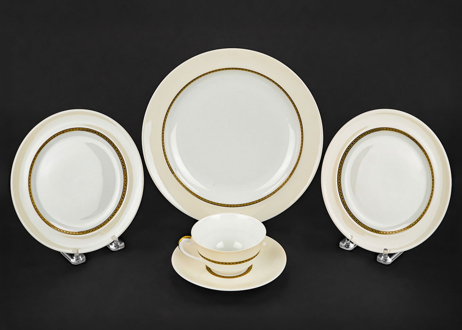 140 pcs. Vignaud Limoges Porcelain Dinnerware: 140 pc. Vignaud Limoges porcelain dinner service with ivory banded border and gilt engraved decoration, including dinner plates, luncheon plates, side plates, double handled bouillon soups, tea cups