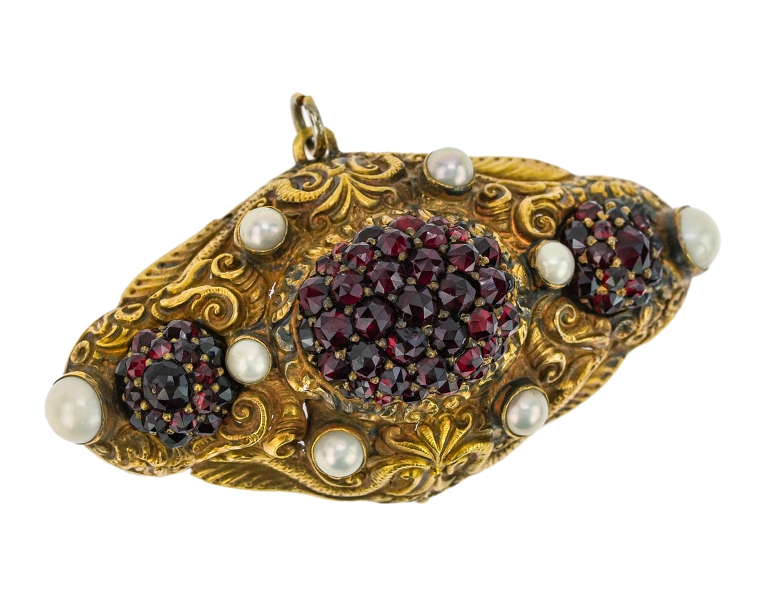 14k Ornate Victorian Garnet & Pearl Brooch: 14k yellow gold Victorian oval brooch pendant with serpent decoration, 7 pearls, and 3 oval clusters of garnets. 2 1/2" long, 1" wide, 3/4" high. 18 grams t.w.