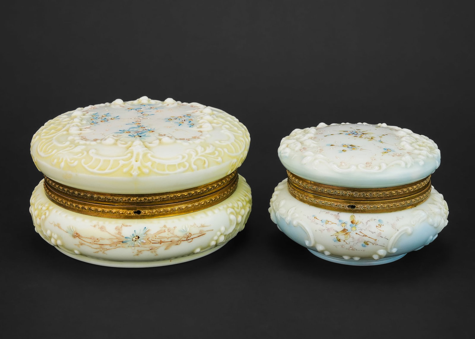 Wavecrest Victorian Art Glass Dresser Boxes: Two late 19th c. C.F. Monroe Meriden, CT "Wavecrest" Victorian art glass dresser jars having handpainted floral enamel decoration on lids and brass frames, overall excellent condition ht. 4", w. 5.5"