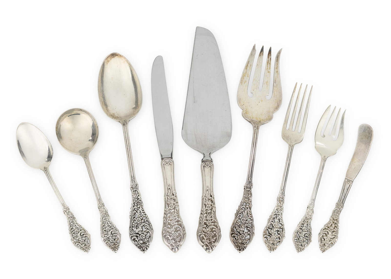 Reed and Barton Florentine Lace Flatware: 75 pcs. Reed and Barton "Florentine Lace" pattern sterling silver flatware having ornately reticulated multi-motif handles with floral and rococo scroll decoration, including 12 dinner forks, 12 dinne