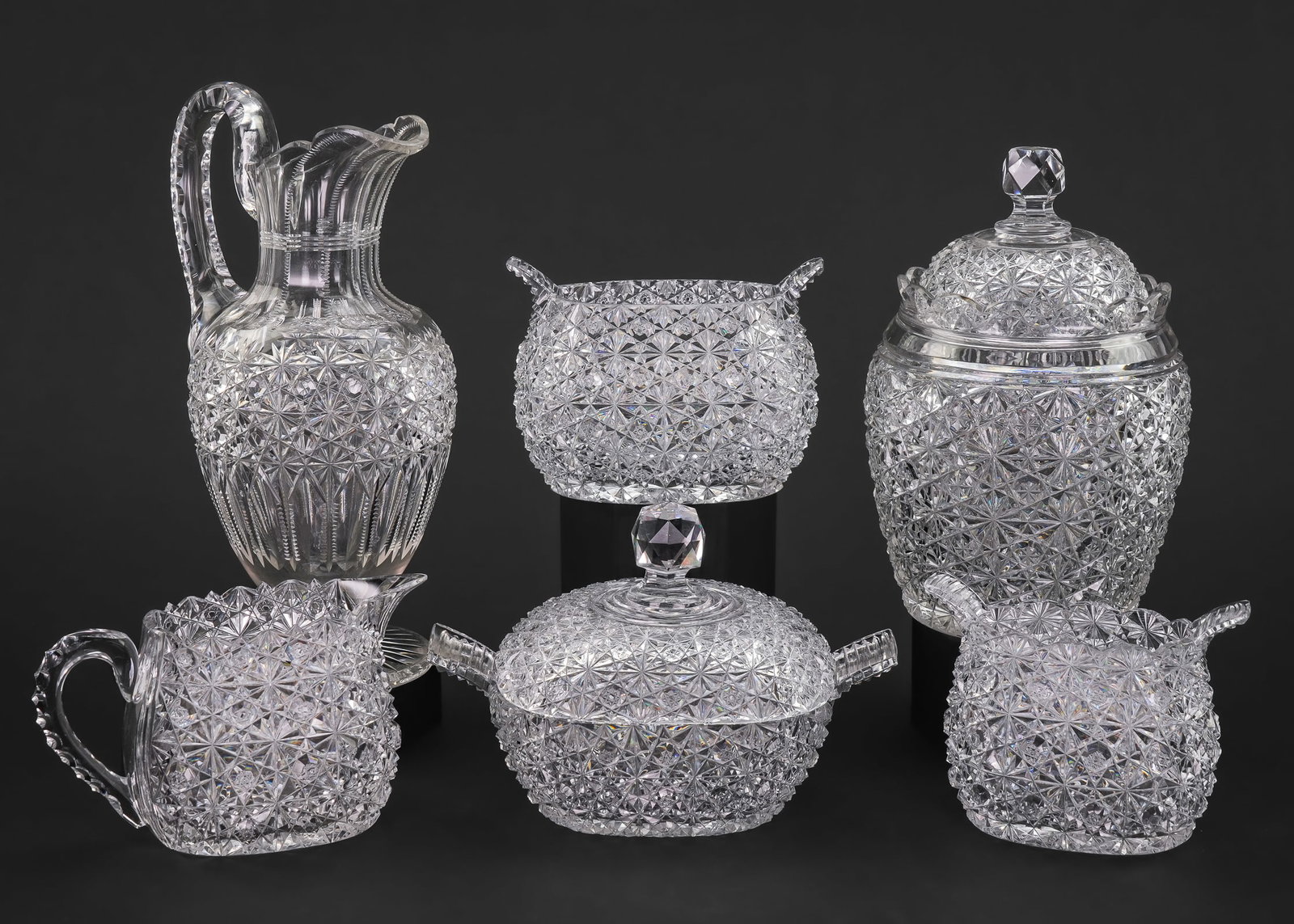 Russian Brilliant Cut Table Set, Jar and Jug: Scarce American Brilliant Period Cut Glass ABCG "Russian" pattern table set including covered sugar bowl, open sugar bowl, creamer, and waste bowl, accompanied by a covered biscuit jar and footed wine