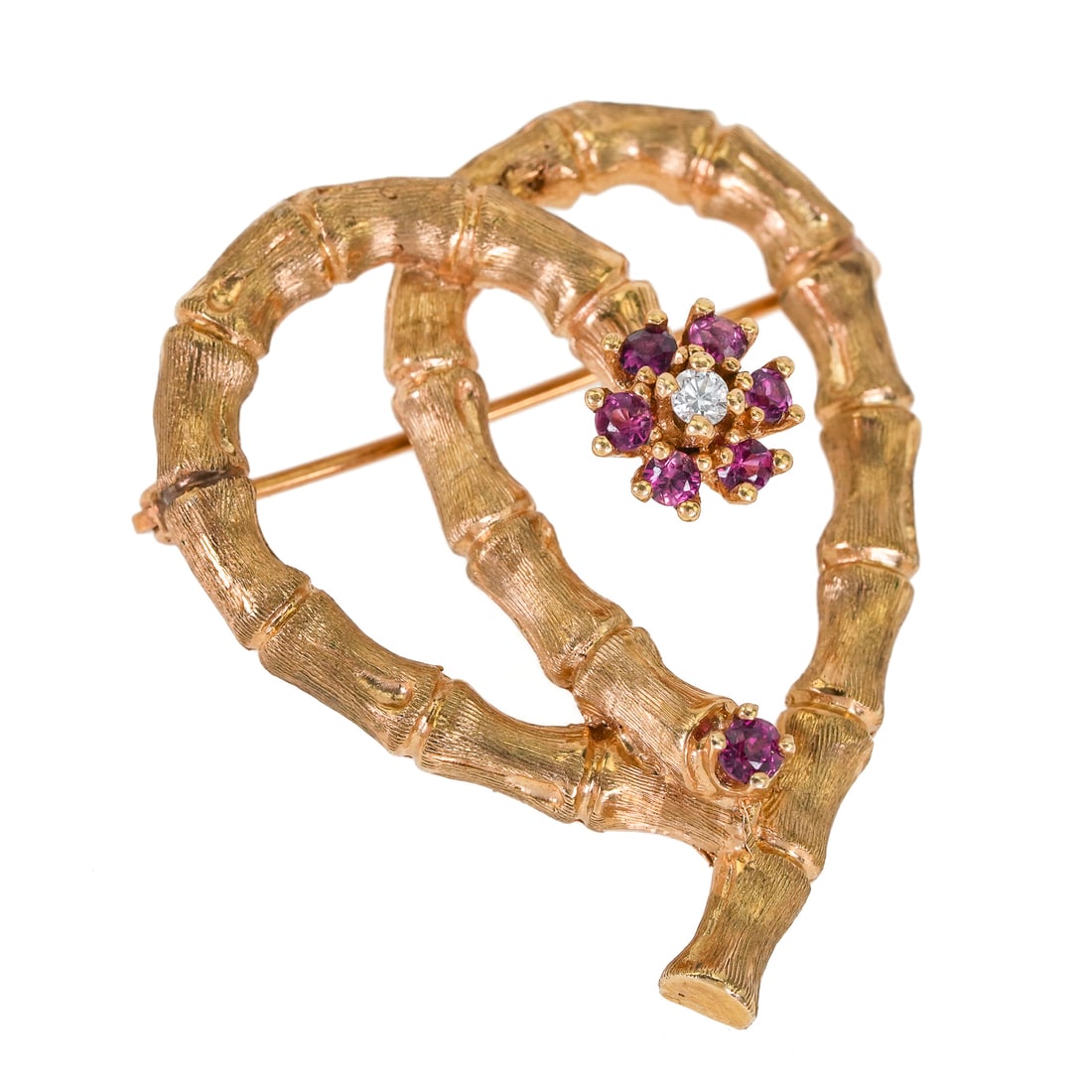 14k Heart Ruby & Diamond Pin: 14k yellow gold pin with bamboo in the shape of a heart. End set with 6 .04 ct rubies and a .05 ct round cut diamond. 11.1 grams t.w. 1 1/2" long.
