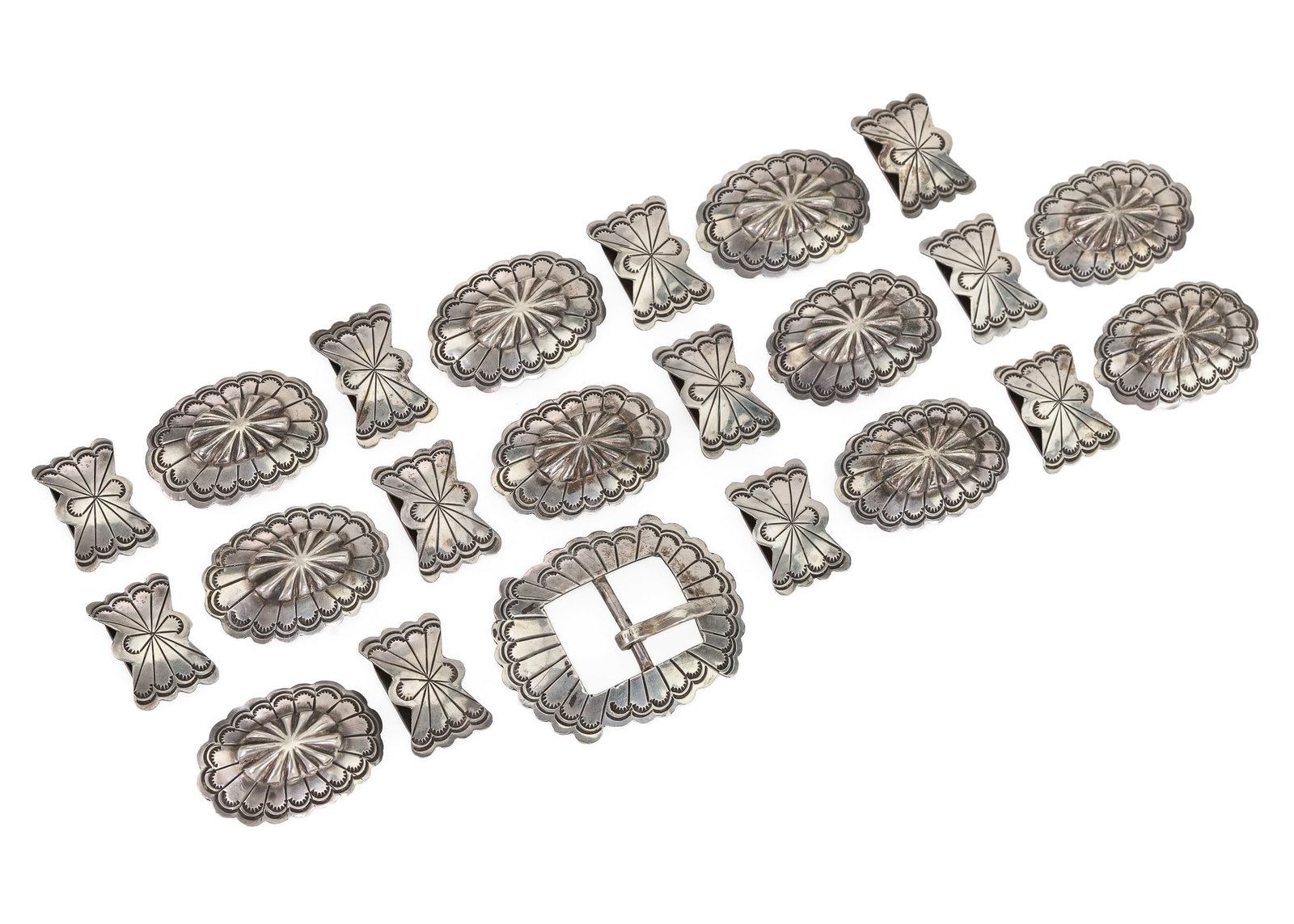 Navajo Concho Belt: 20th c Navajo sterling Concho belt with buckle (2" x 1/2"). 10 conchos (1 5/8" x 1"). 11 butterflies (1 1/8" x 3/4"). Buckle marked sterling J. No leather.